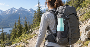 VSITOO S1 Pro self-cleaning water bottle in a backpack side pocket on a hiking trail