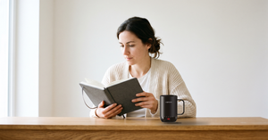 VSITOO S3 Pro self-heating coffee mug within reach of a reader at a home desk